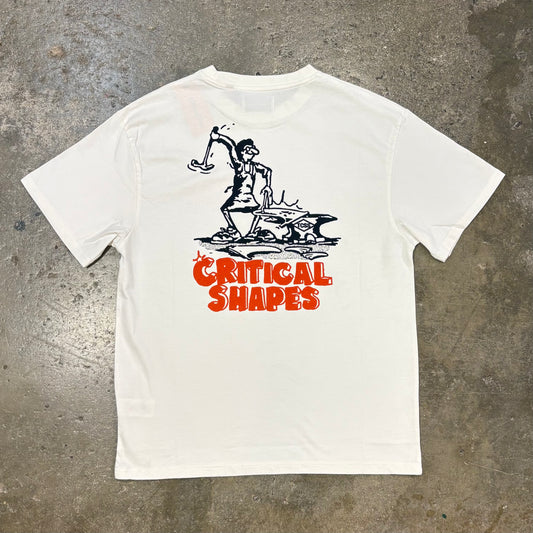 White t-shirt with black and red graphic design on a concrete surface