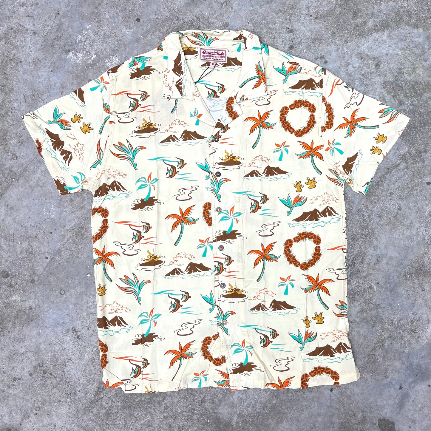 Short-sleeve shirt with tropical pattern on a gray surface