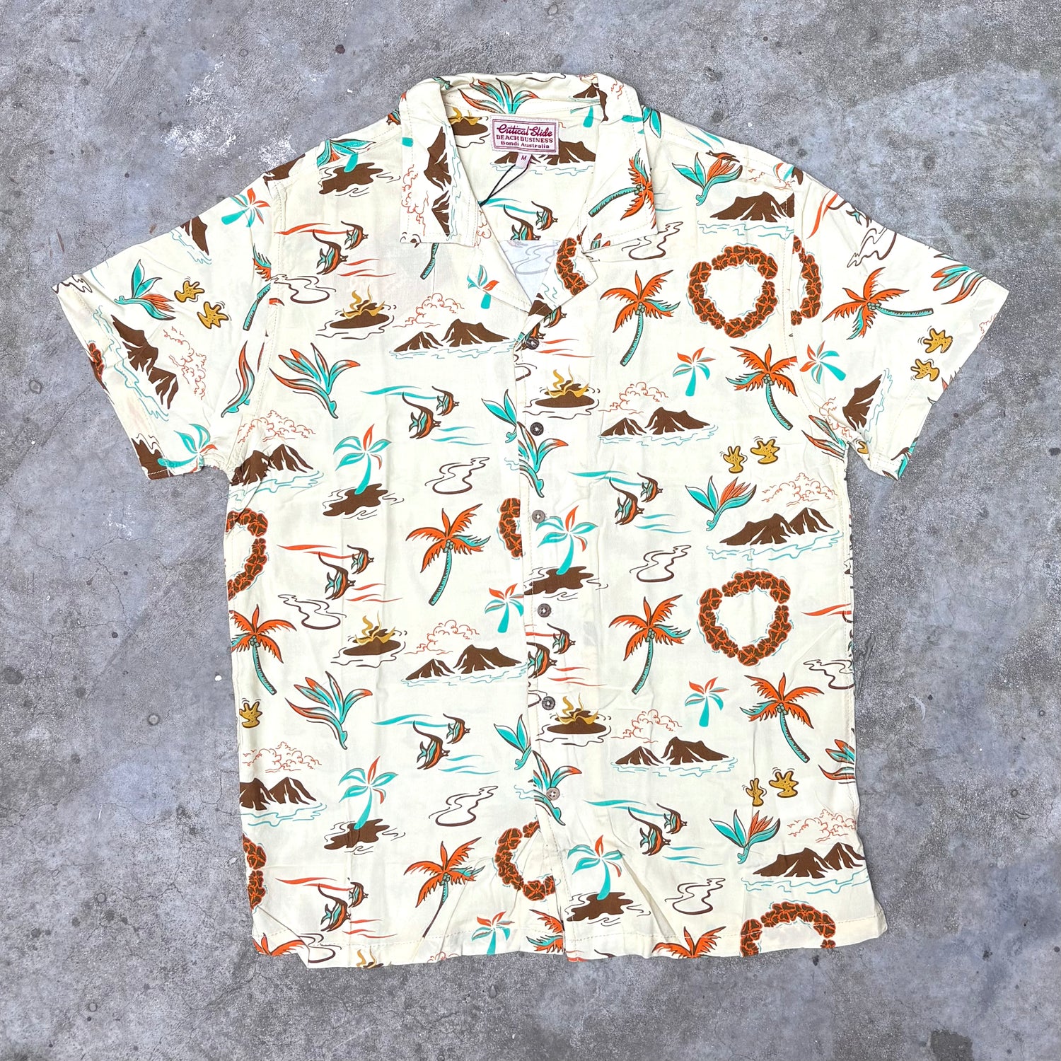 Short-sleeve shirt with tropical pattern on a gray surface