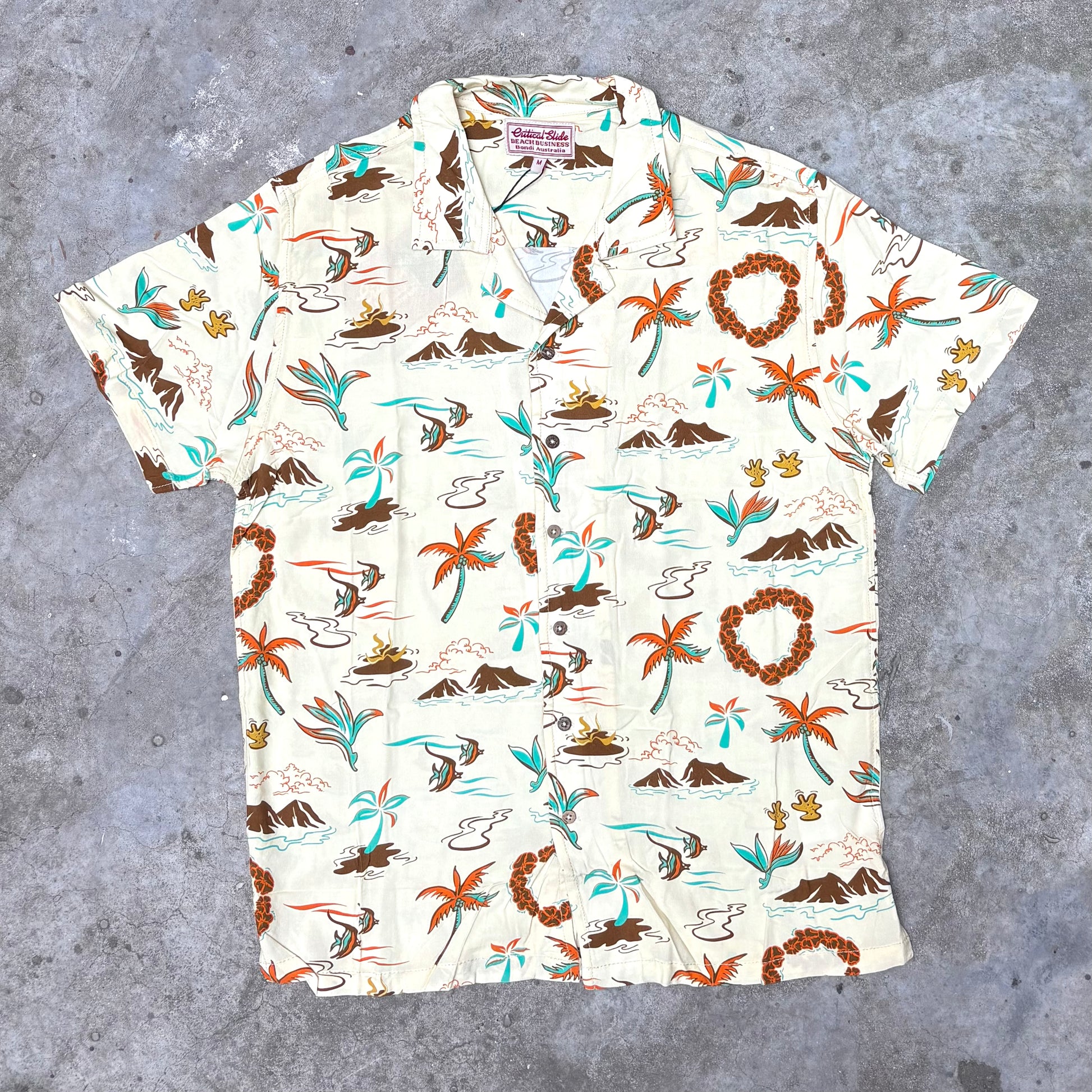 Short-sleeve shirt with tropical pattern on a gray surface