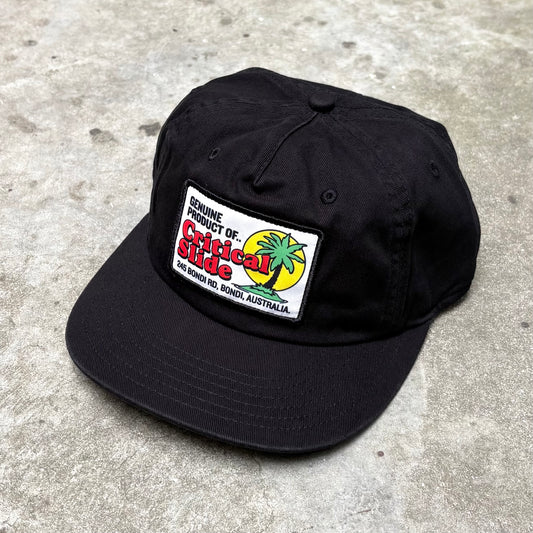 Black cap with badge on concrete surface