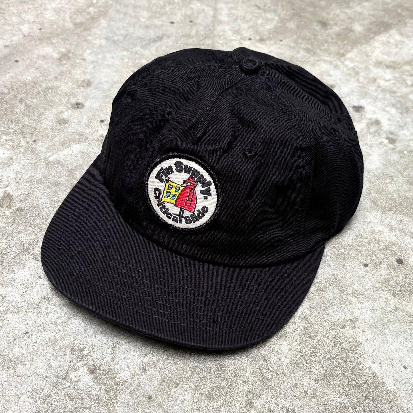 Black Supply Cap on concrete surface.