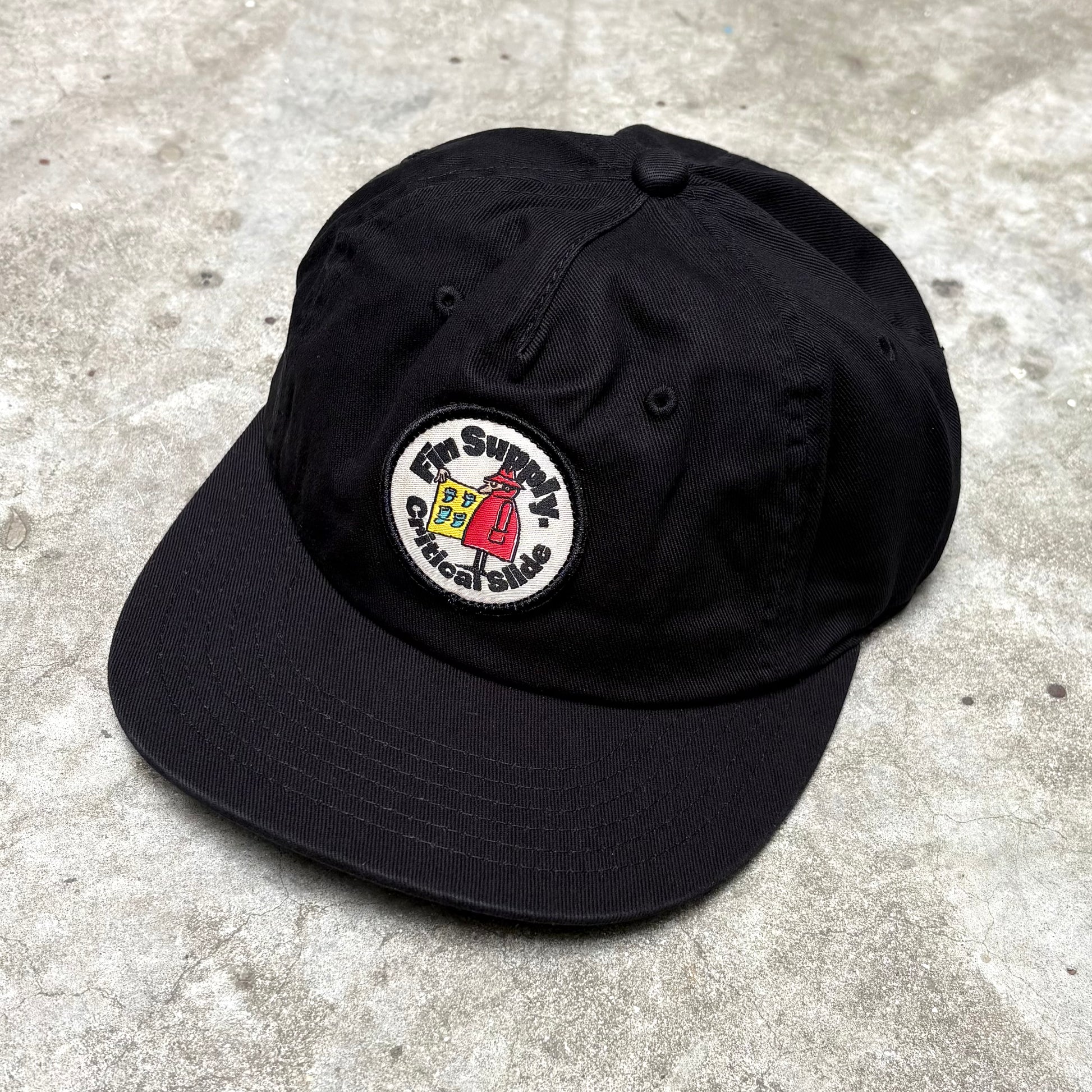 Black Supply Cap on concrete surface.