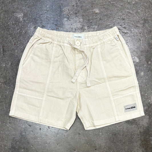 Beige shorts on a gray concrete surface