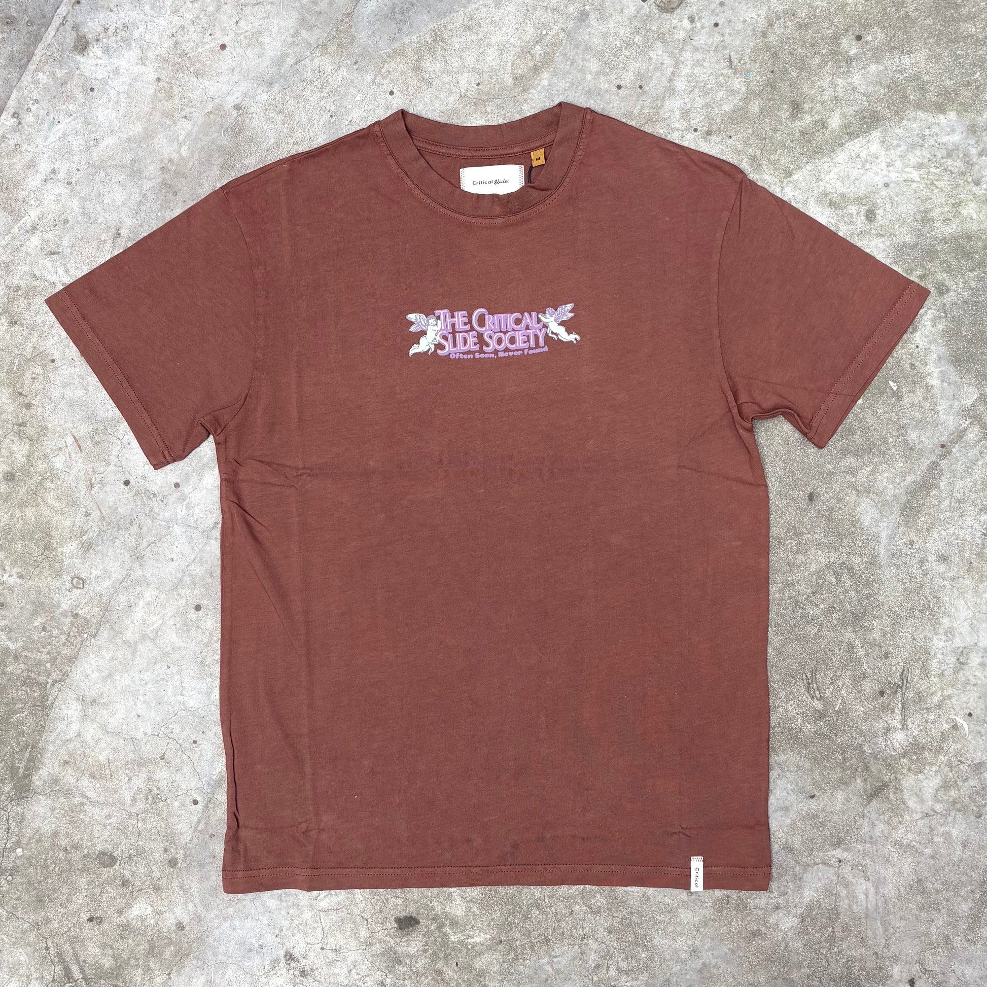 Brown t-shirt with a logo on a concrete surface