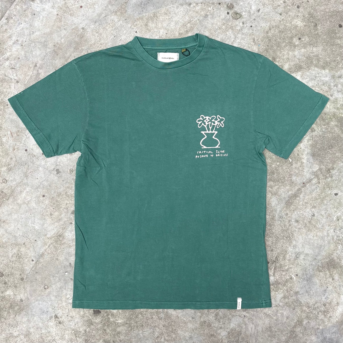 Green t-shirt with a white graphic on a textured surface