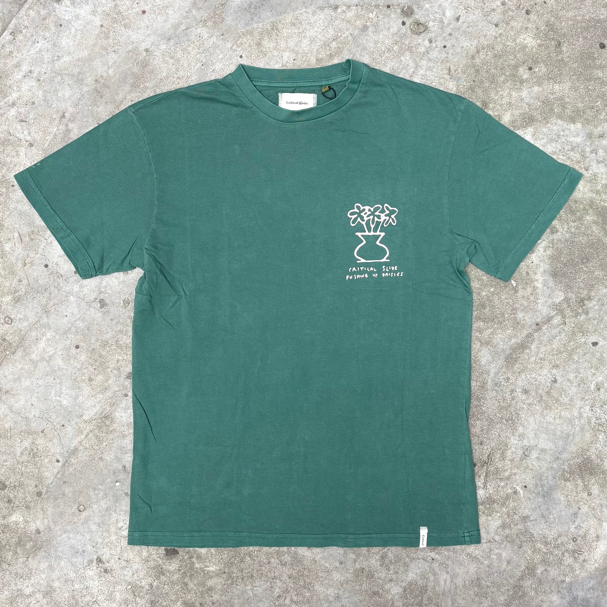 Green t-shirt with a white graphic on a textured surface
