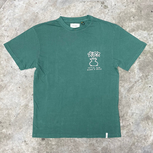 Green t-shirt with a white graphic on a textured surface