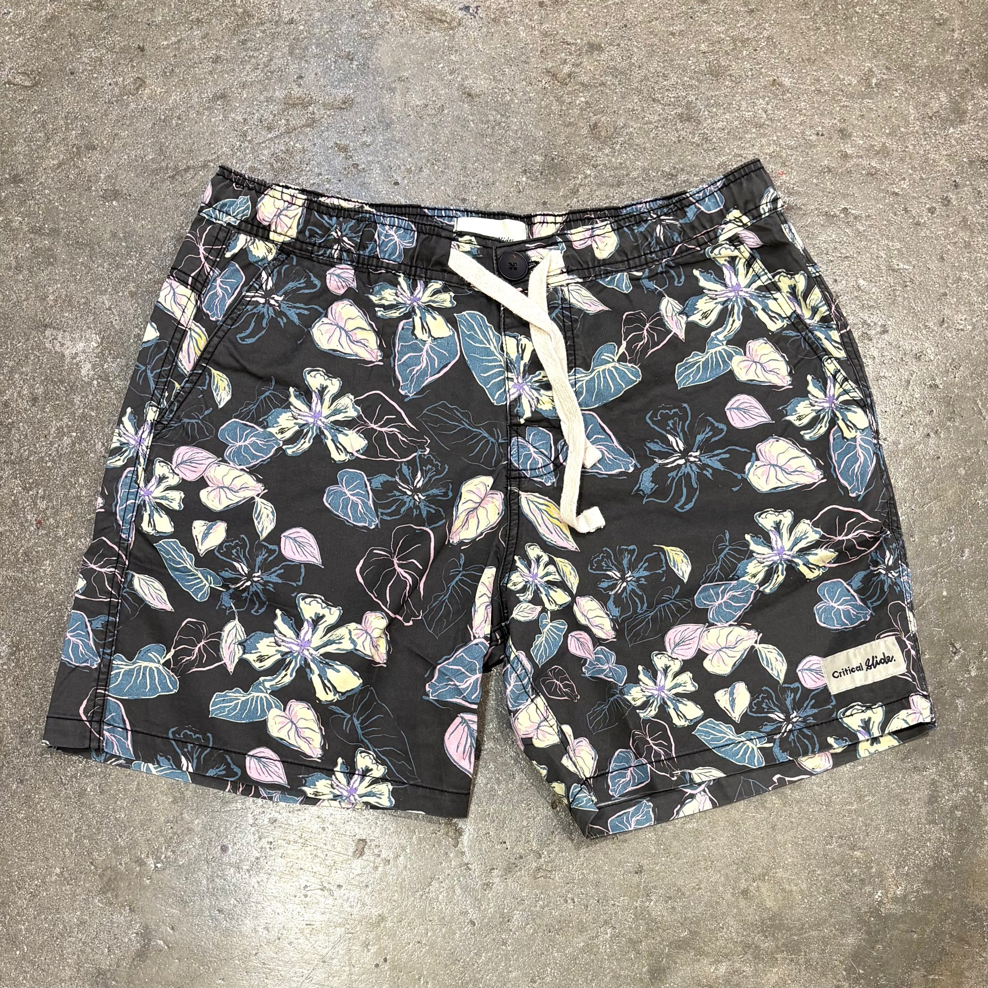 Floral-patterned shorts on a concrete surface