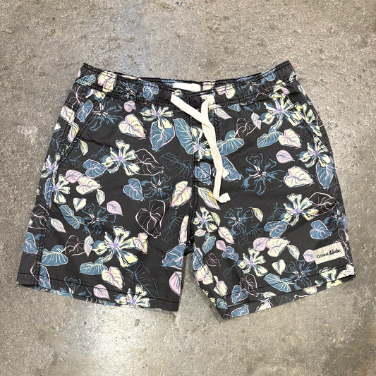 Floral-patterned shorts on a concrete surface