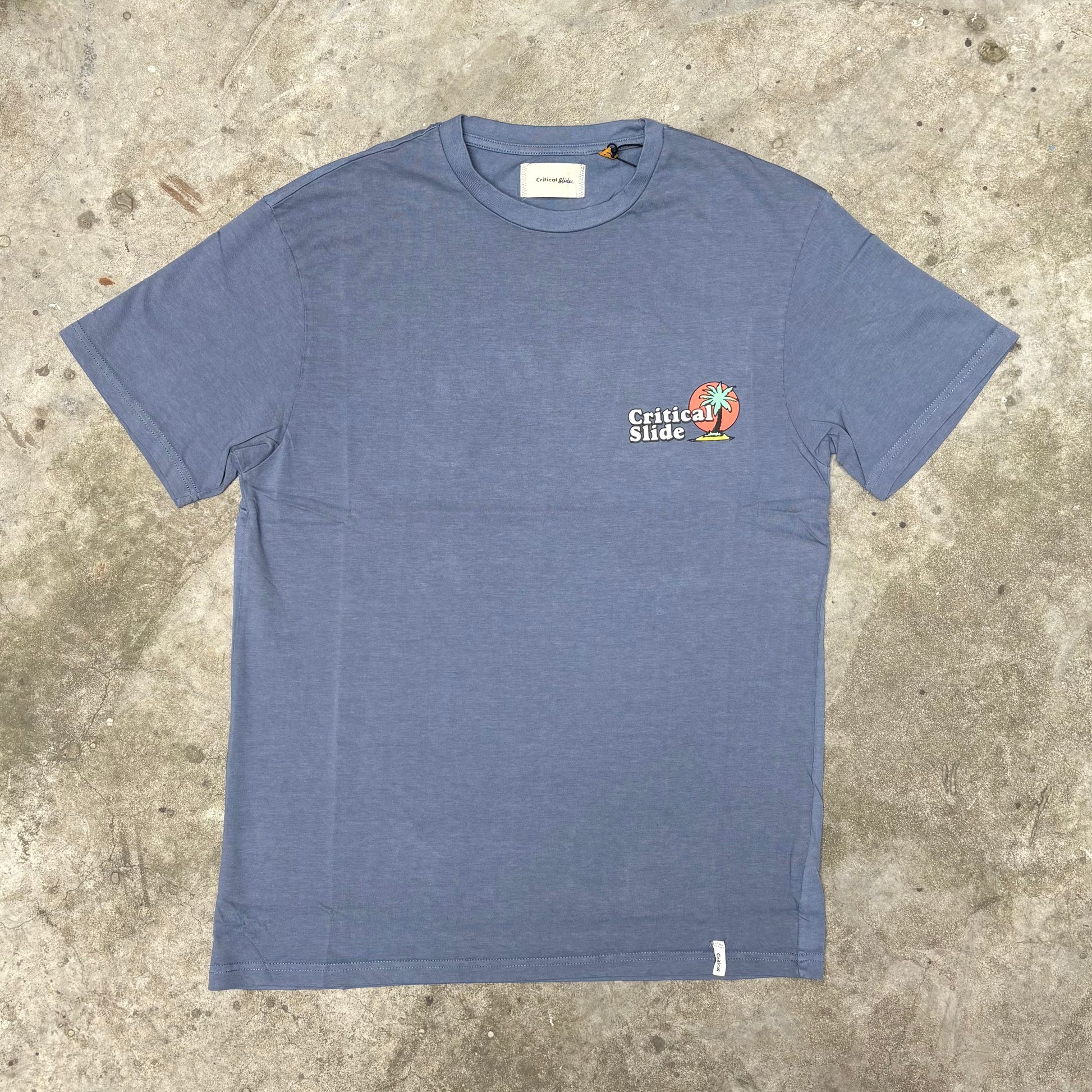 Blue t-shirt with a logo on a concrete surface