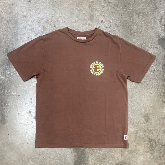 Brown t-shirt with a logo on a gray concrete surface