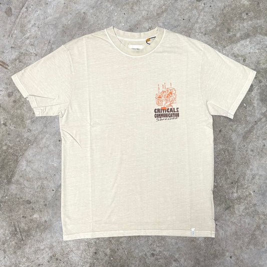 Beige t-shirt with a logo on a gray concrete surface