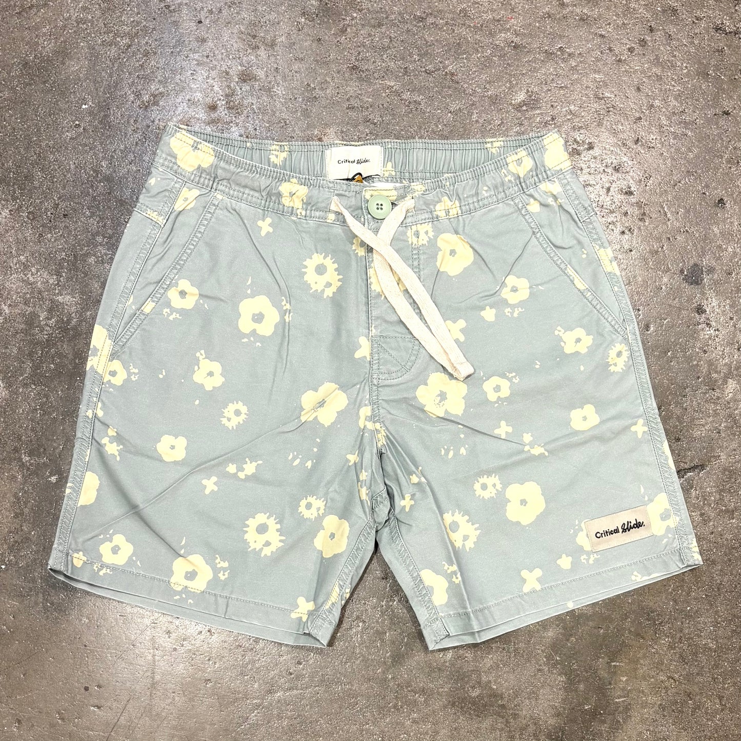 Floral patterned shorts on a concrete surface