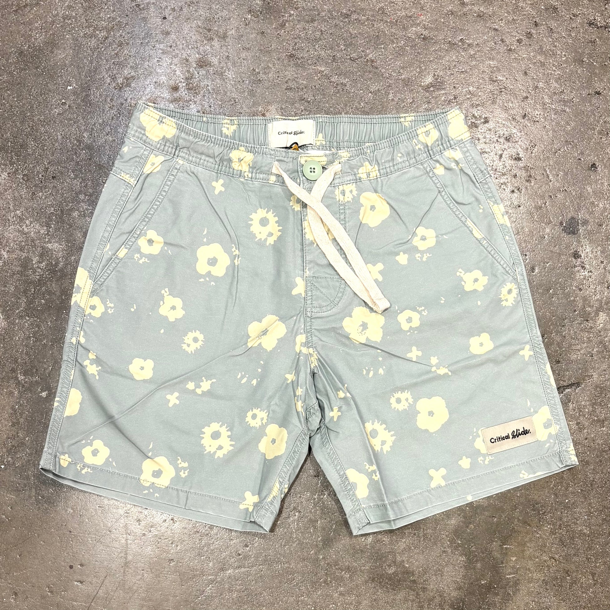 Floral patterned shorts on a concrete surface