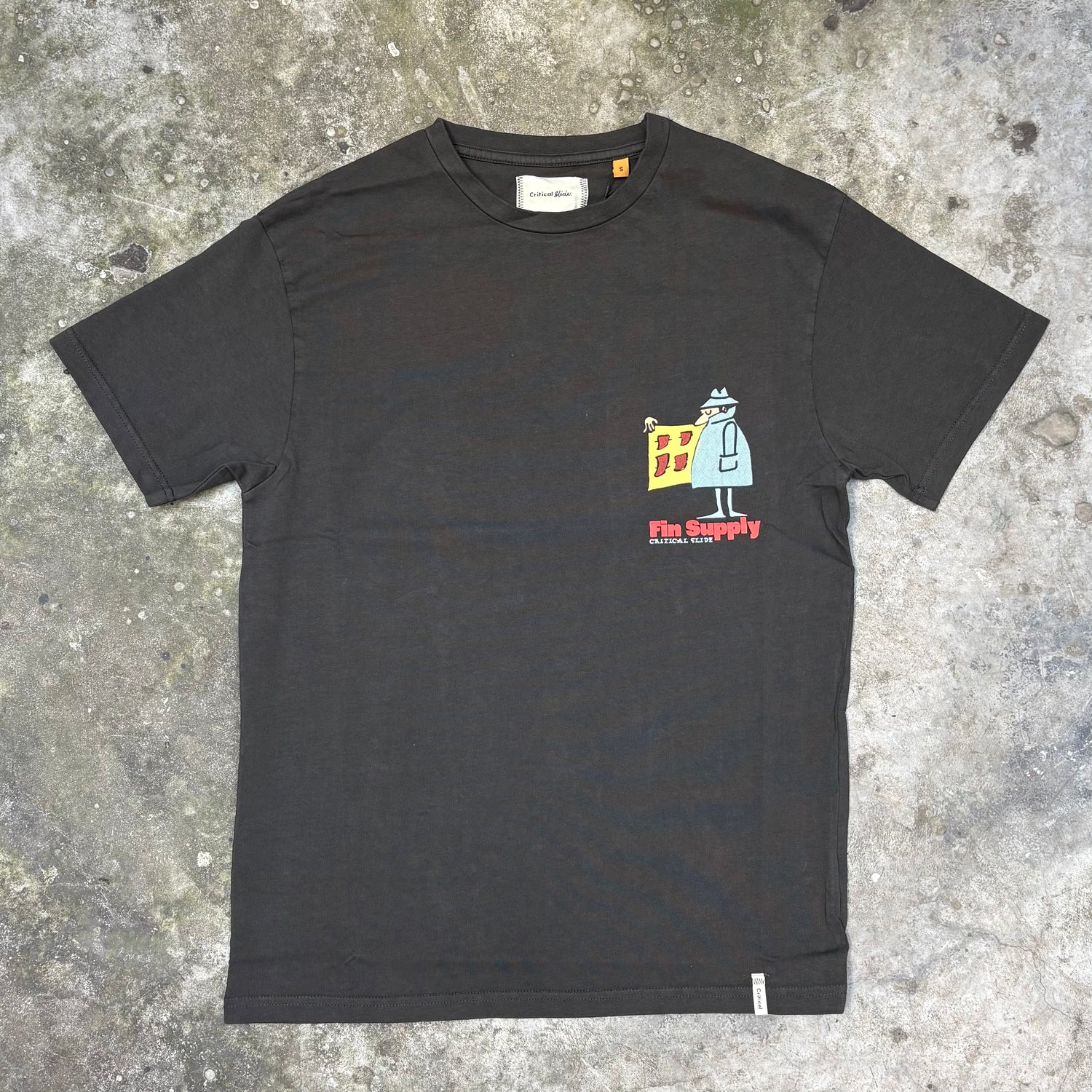 Black t-shirt with a graphic design on a concrete surface