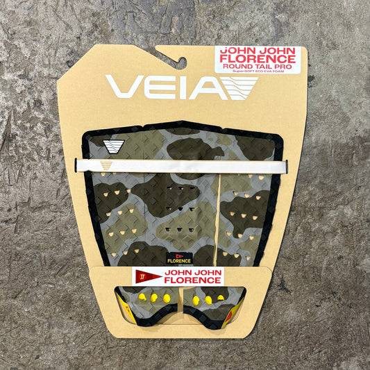 Veia surfboard tail pad packaging with John John Florence branding on a textured gray background