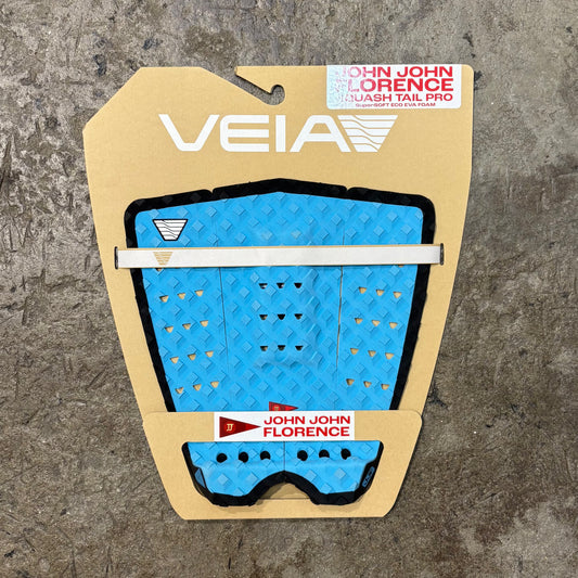 Blue surfboard tail pad with 'VEIA' branding on a textured surface