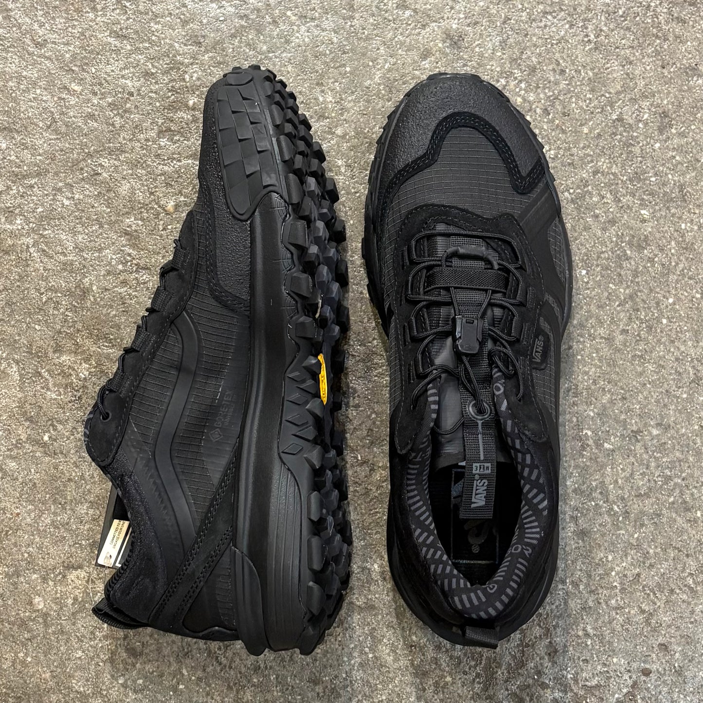 Black hiking shoes on a concrete surface