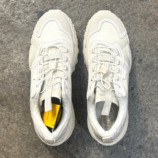 Pair of white sneakers on a gray concrete surface