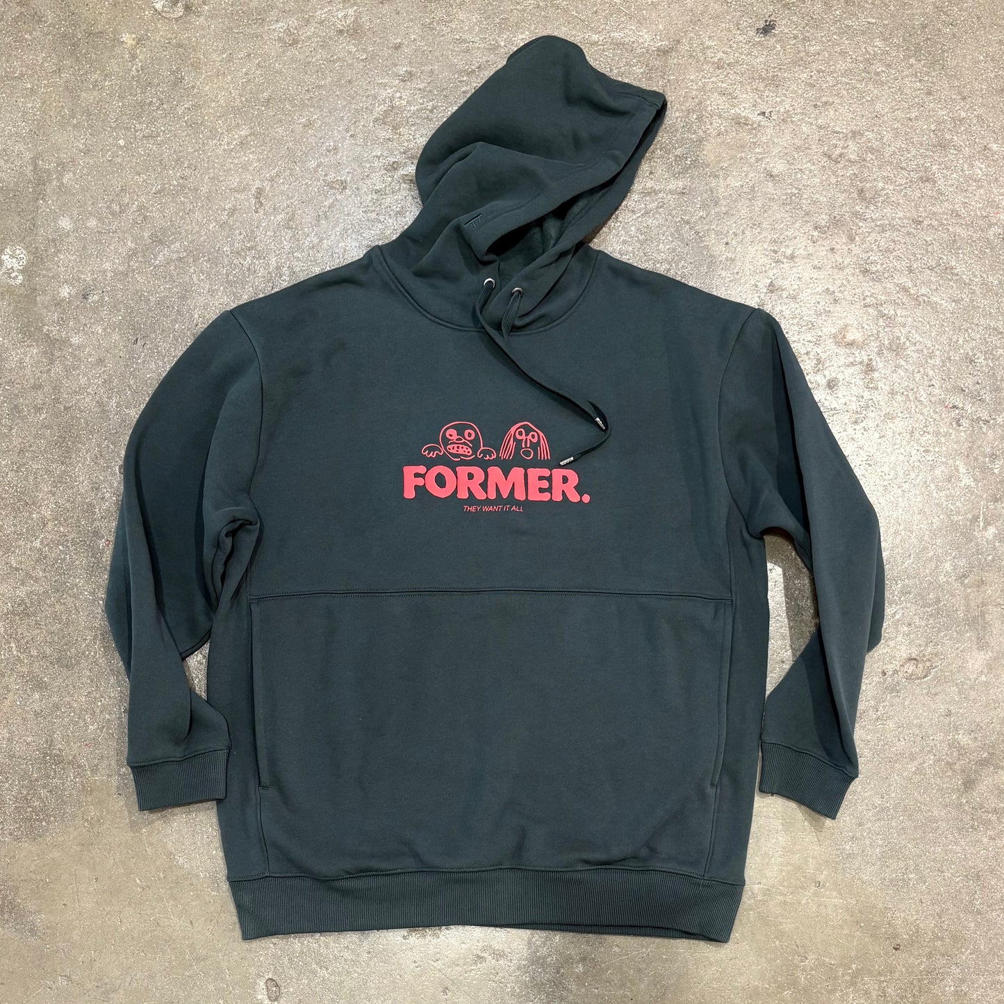 Green Want it all Hood on concrete surface