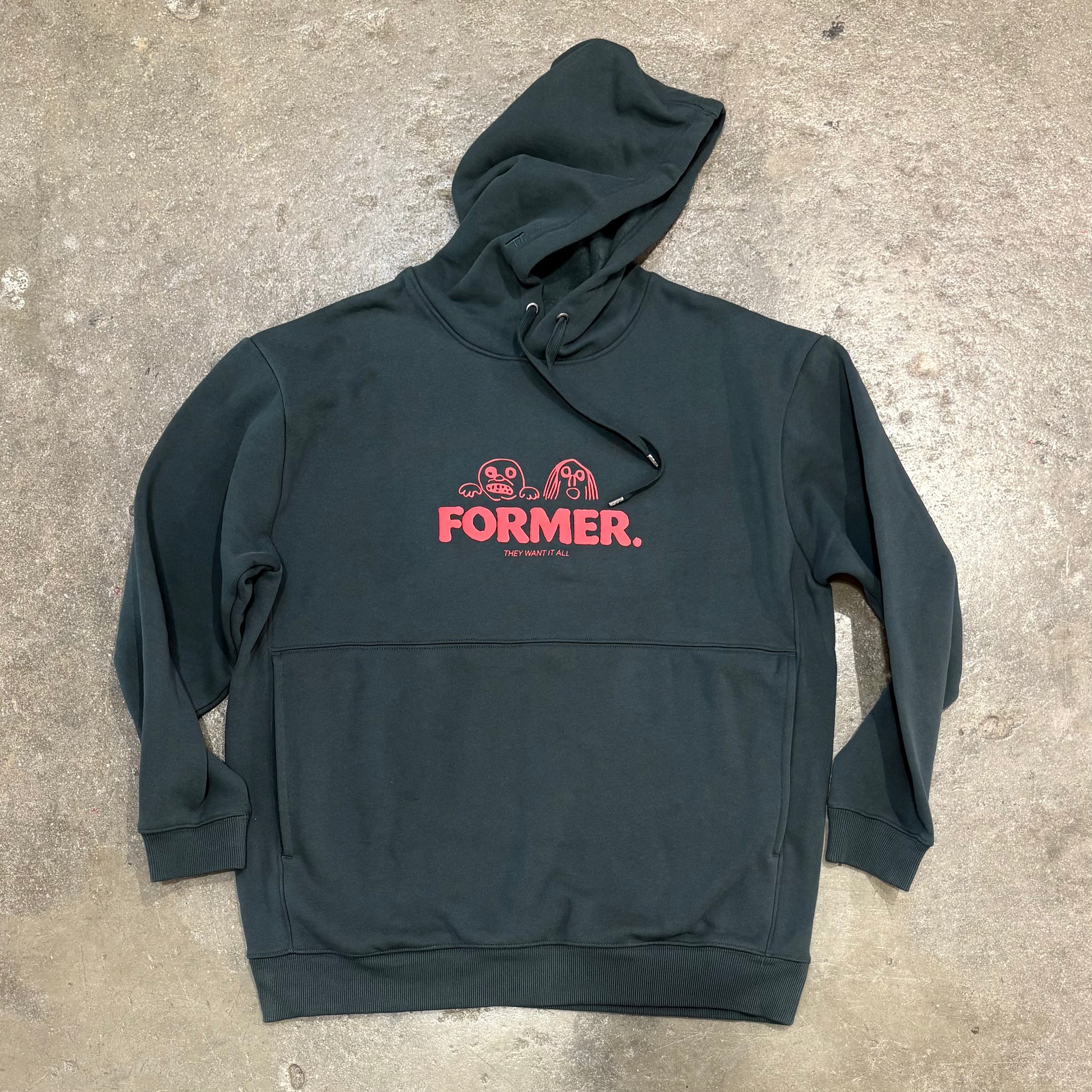 Green Want it all Hood on concrete surface