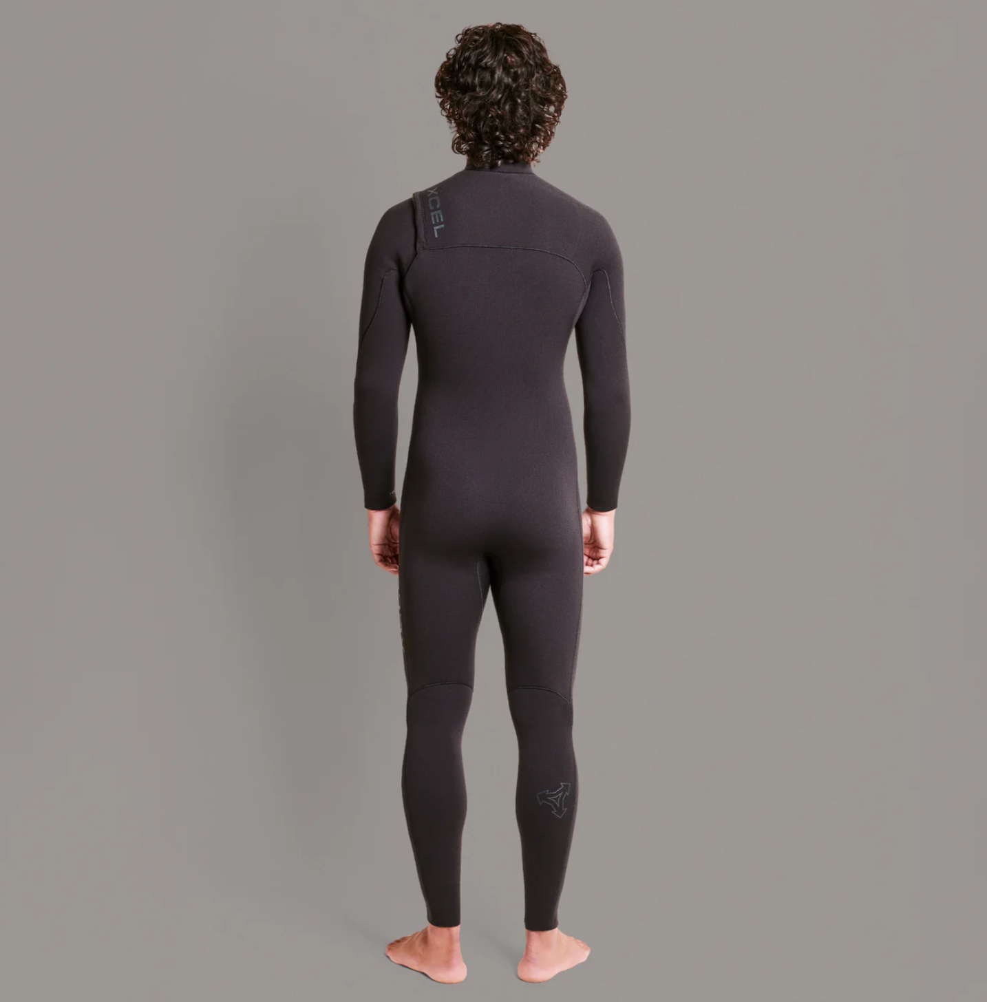 Back view of stock shot of model wearing the Xcel Comp+ 4/3mm - Black - Men's Full Suit