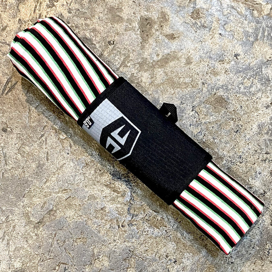 A longboard with a black drawstring and a striped pattern in green, white, and red, featuring the Hurricane brand logo on the side.