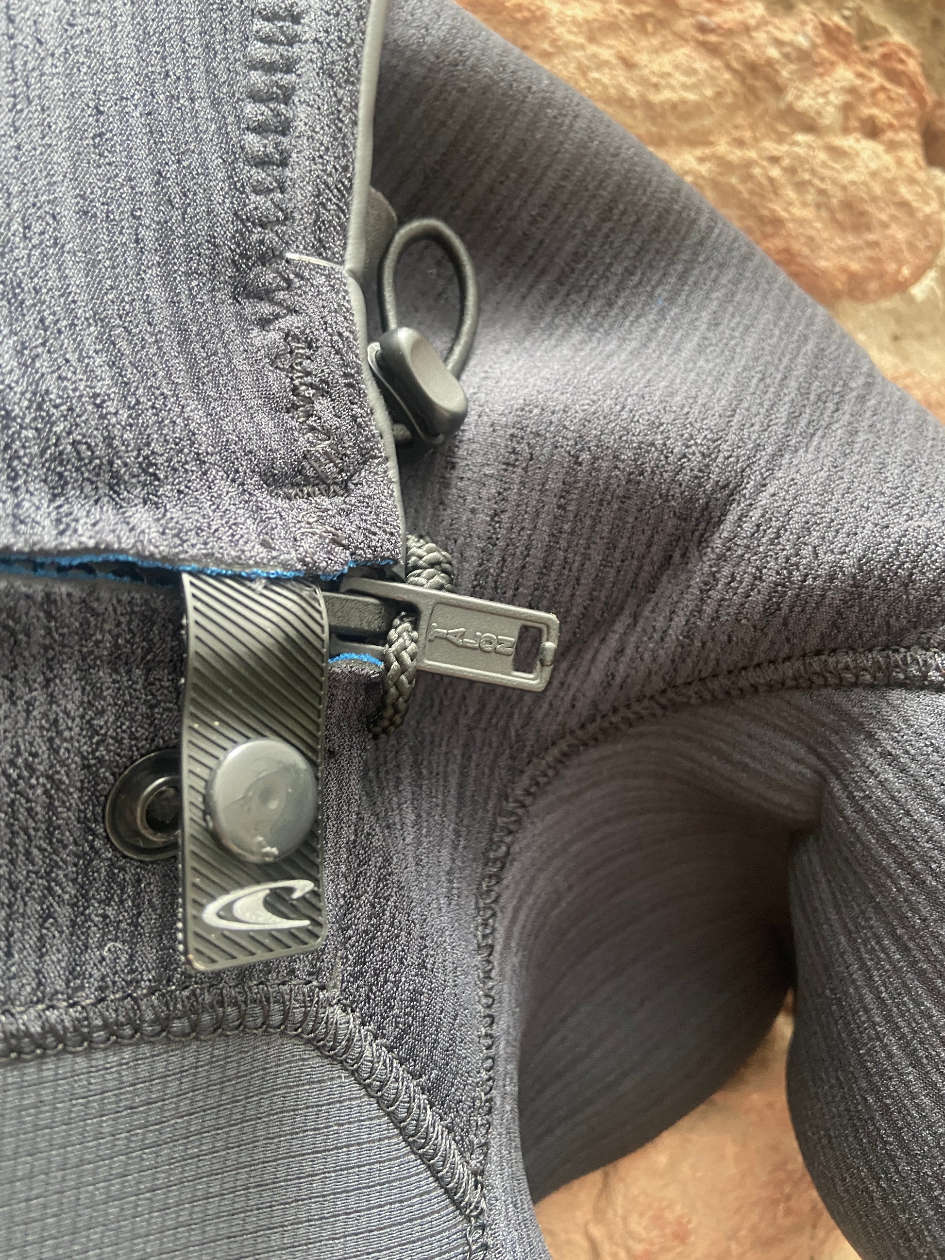 Detailed view of the zip closure on the O'Neill Hyperfreak 3/2mm+ Chest Zip - Black - Men's wetsuit